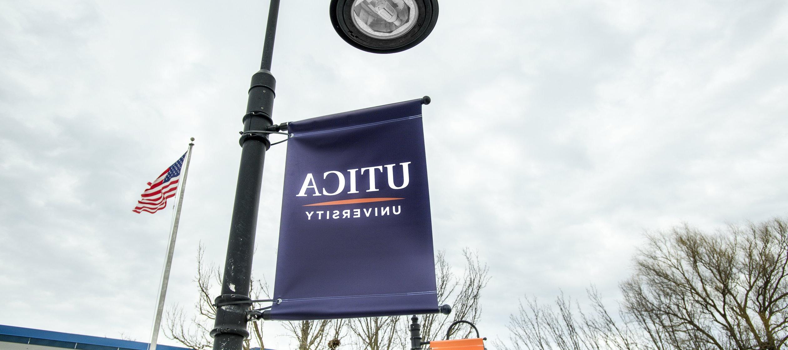 Utica banner on campus