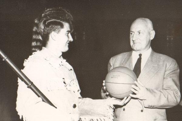 Pioneer mascot handed basketball.