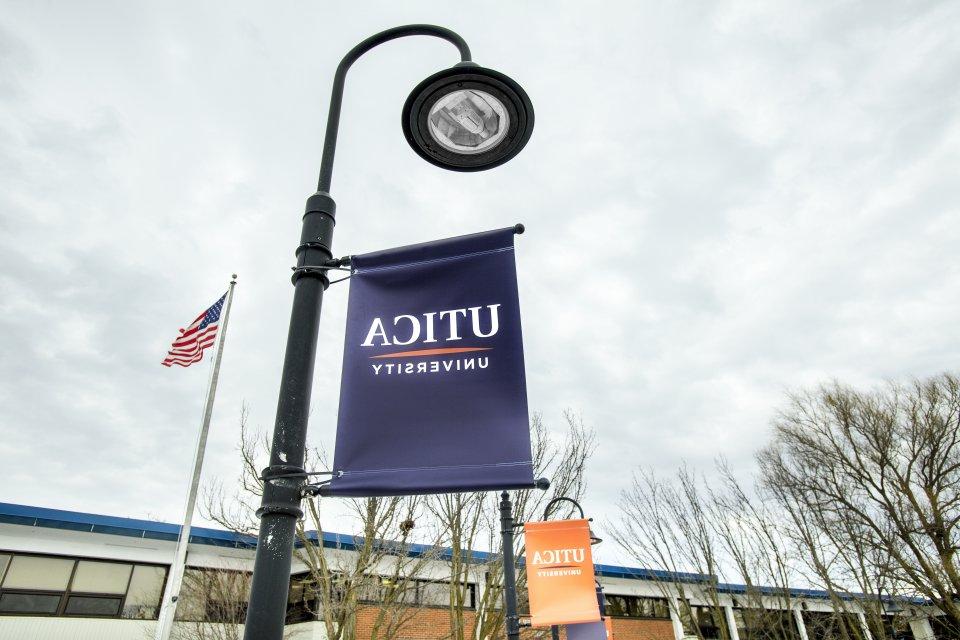 Utica banner on campus