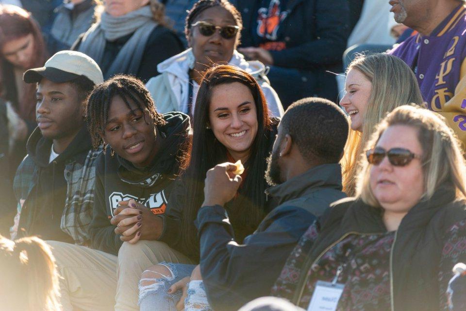 Homecoming crowd sitting in bleachers.